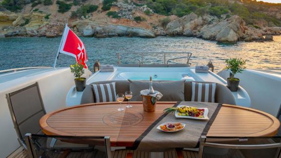 Cosmos yacht offers a peaceful evening with wine, fruit, and jacuzzi views at golden hour.