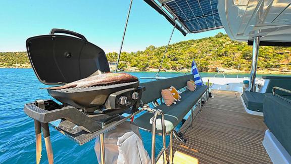 The aft deck of Ace of Hearts in Athens features a barbecue grill, seating area and sea view.