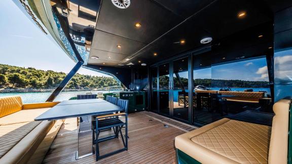 The spacious aft deck offers a relaxed, shaded lounge area aboard the charter-ready Over the Moon in Split.