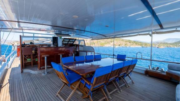 Dining table and chairs on the aft deck of Gulet Cemre Junior.