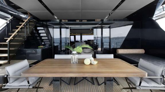 Stylish dining table on Sunreef Catamaran with modern decor and sea view.