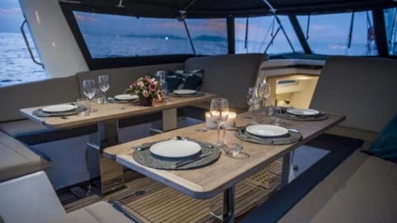 The cockpit of the Life Time yacht is set for a romantic candlelit dinner with a sea view.