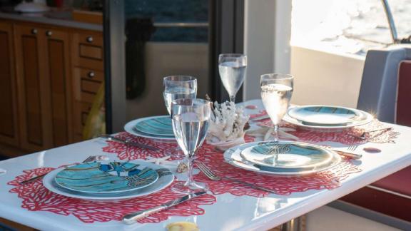 Barbaros 3 lobster yacht deck with sea-themed plates and elegant water glasses.