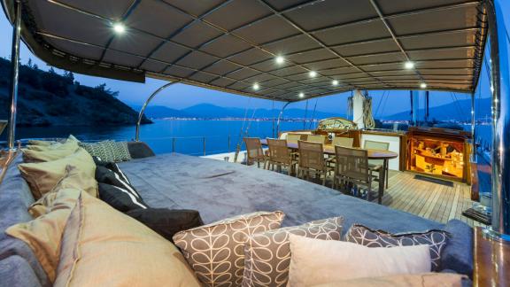 beleuchtete Achterdeck eines Motorseglers in Fethiye bei Nacht, ideal für Dinner und Entspannung.