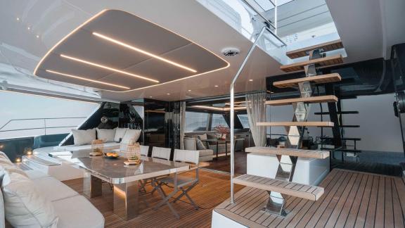 Elegant dining area and modern staircase on the Catamaran Alteya, featuring luxurious interior and ambient lighting.