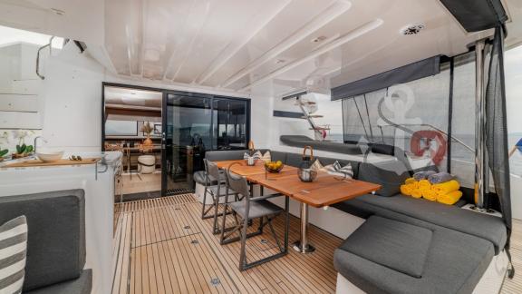 Elegant dining area on the aft deck of the catamaran Princess S with a sea view near Split, Croatia