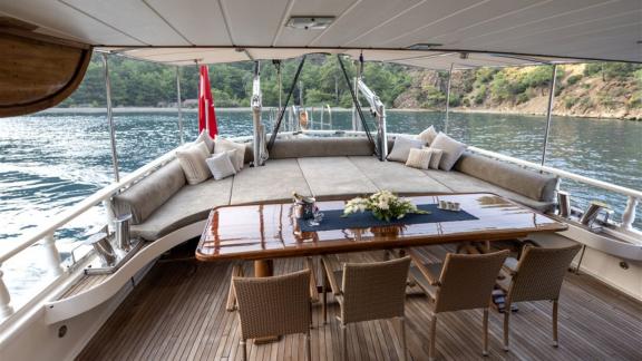 Luxurious dining and lounge area on the Kayhan yacht, surrounded by stunning nature.