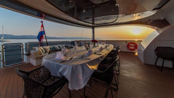 Set table in the dining area of Omnia at sunset.