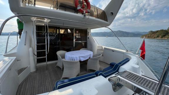 Elegant dining area on the aft deck of motor yacht Sky 22 with a sea view offers enjoyment.