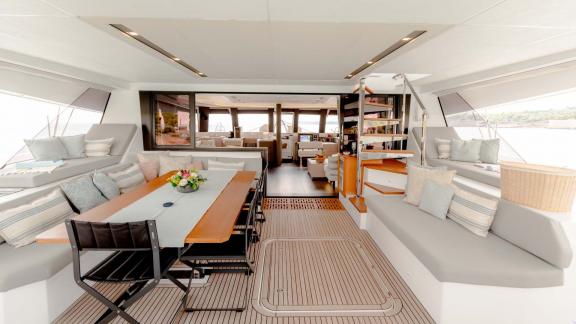 Stylish interior with dining table and cozy seating area aboard the yacht