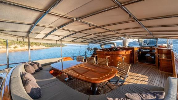 Covered dining area on board the gulet Bedia Sultan from Bodrum, ideal for meals with a sea view.