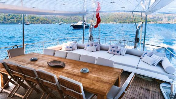 Dining table and seating area on the deck of a gulet.