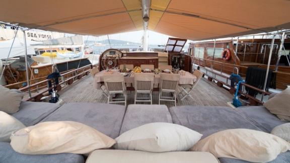 Spacious dining area and cozy seating on the Gulet Optimist in Bodrum.