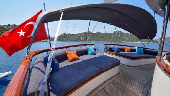 Covered lounge area on the deck of a gulet in Marmaris with comfortable seating and cushions