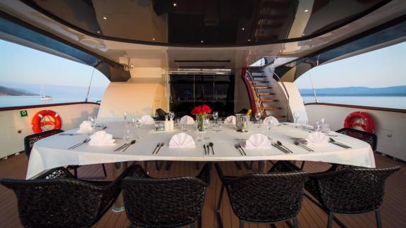 Elegant set table in the dining area of Omnia with a sea view.