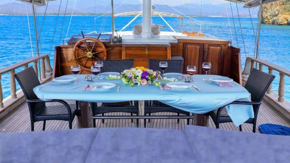 Well-set dining table on the Gulet Hasay with picturesque sea view and romantic ambiance.