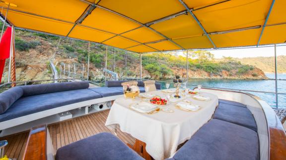 Elegant dining area on Guletcharter Hülyam 2 in Göcek with a stunning view of the water.