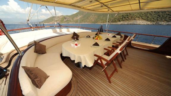 The covered dining area of the gulet Dear Lila offers shelter and comfort for meals on board.