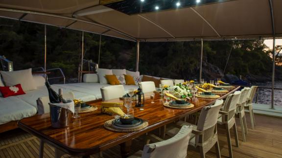 Elegant dining area on the Grand Acar Gulet at dusk in Fethiye.