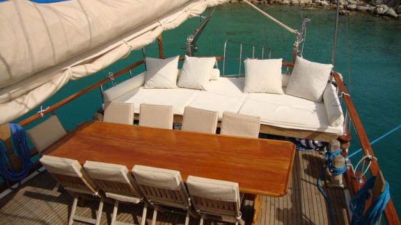 Cozy dining area and sun loungers on the deck of Gulet Tufan 5 with sea view.