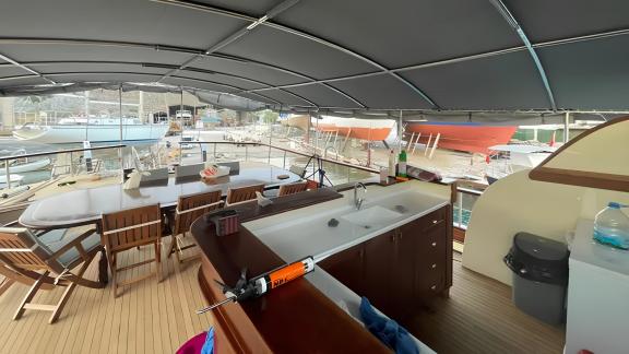 The spacious deck area of Gulet Enver Aga in Marmaris, featuring a seating area and a workspace, perfect for social gath