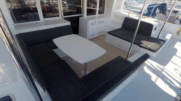 Spacious outdoor dining area with comfortable seating on the Zuzo 2 catamaran.