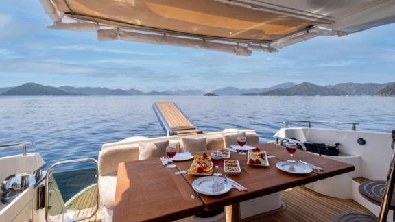 Dining setup and sea view on the aft deck of motor yacht Blue My Story.