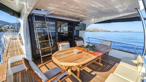 Spacious dining area and comfortable seating on the aft deck of motor yacht Ata Bora in Bodrum.