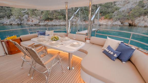 Outdoor lounge of the 3-cabin Gulet Limonata in Göcek, Turkey, with sea view.