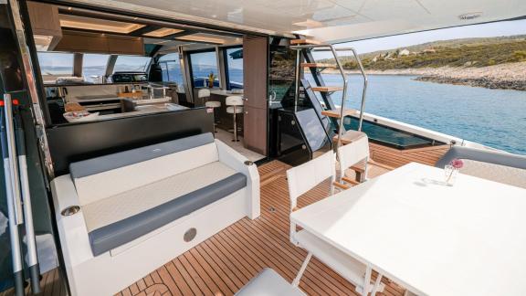 The FG Star yacht features a modern outdoor dining and seating area.