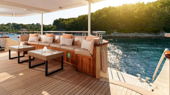 Cozy seating area on the deck of the motor yacht Queen Eleganza overlooking the Croatian coast