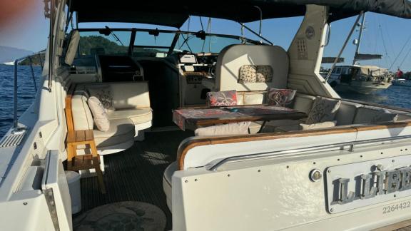 Comfortable seating area and table on the aft deck of motor yacht Liberta.