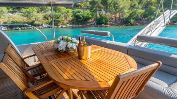 The stylish dining area on the aft deck of motor yacht Selenge is perfect for outdoor meals.