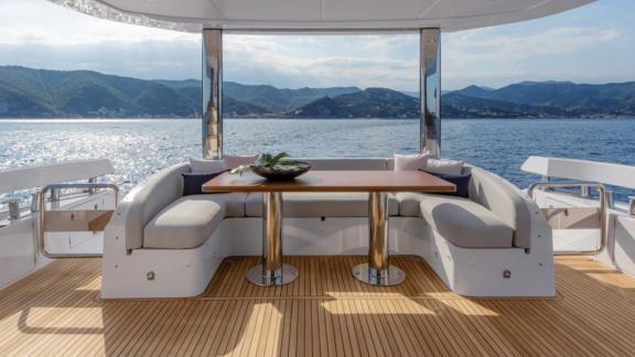 Stylish dining area with comfortable seating and a view of the sea and mountains.