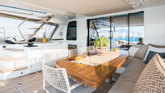 The cozy dining area inside White Caps catamaran features an elegant table and comfortable seating.