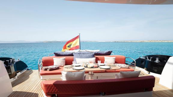 The aft deck of Um7 features a cozy dining area with a sea view.