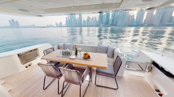 The dining area of the Ferretti 780 motor yacht offers an elegant setting for an unforgettable daily yacht rental in Dub