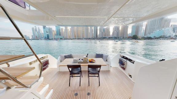 The aft deck of the Ferretti 670 motor yacht adds comfort and style to your luxurious yacht rental experience in Dubai.