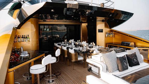 Experience stylish outdoor dining on Ak Royalty with Dubai luxury yacht rentals.