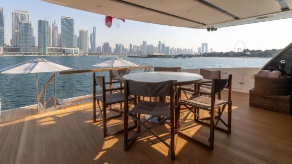 The open-air dining space on San Lorenzo Sx88 turns your luxury yacht rental in Dubai into an unforgettable pleasure.