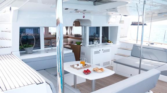 The aft deck of the Balok catamaran features a comfortable seating area and an open kitchen.