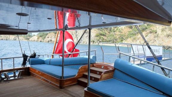 Cozy seating areas on the aft deck of gulet Queen Atlantis with a sea view.