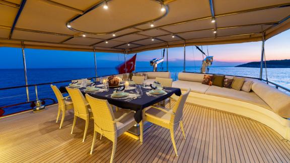 The aft deck of Mein Schatz features a spacious seating area and a stylish dining table, perfect for luxury gulet charte