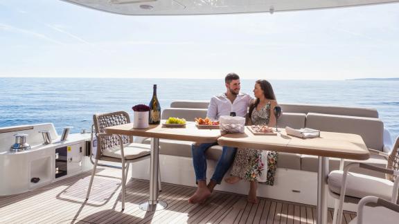 Couple enjoying the view and conversation on the outer deck of Sirena 64.