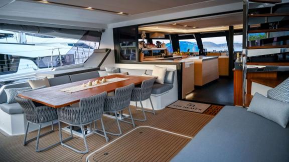 Spacious table and comfortable seating on the aft deck of the 7th Heaven catamaran in Athens.