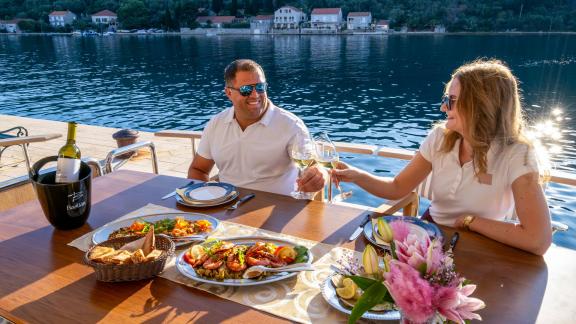 A refined dining moment awaits aboard the Menorquin 68 FB motor yacht Cloud 9, set on the aft deck with sweeping coastal