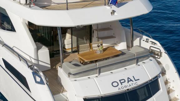 The Sunseeker 75 offers a stylish seating area with drinks served on the aft deck overlooking the sea.