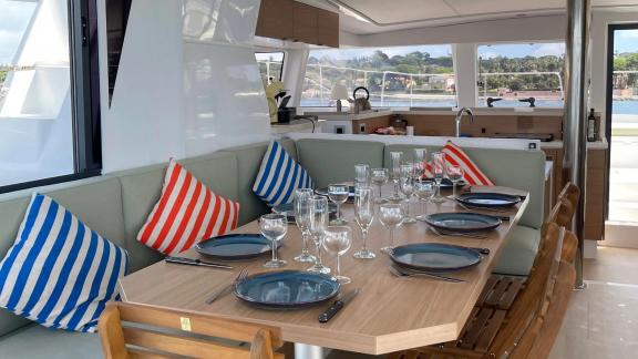 Enjoy delicious meals with sea views in the spacious dining area inside the salon of the Christeol catamaran.