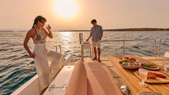 Anchored off Lavrion the 3 cabin 6 guest Omikron Yachts OT 60 N ice with sunset dining on the aft deck.
