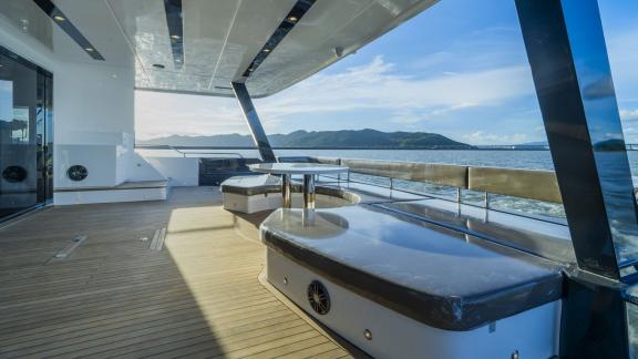 Evita power catamaran features a spacious aft deck with comfortable seating and open sea views.